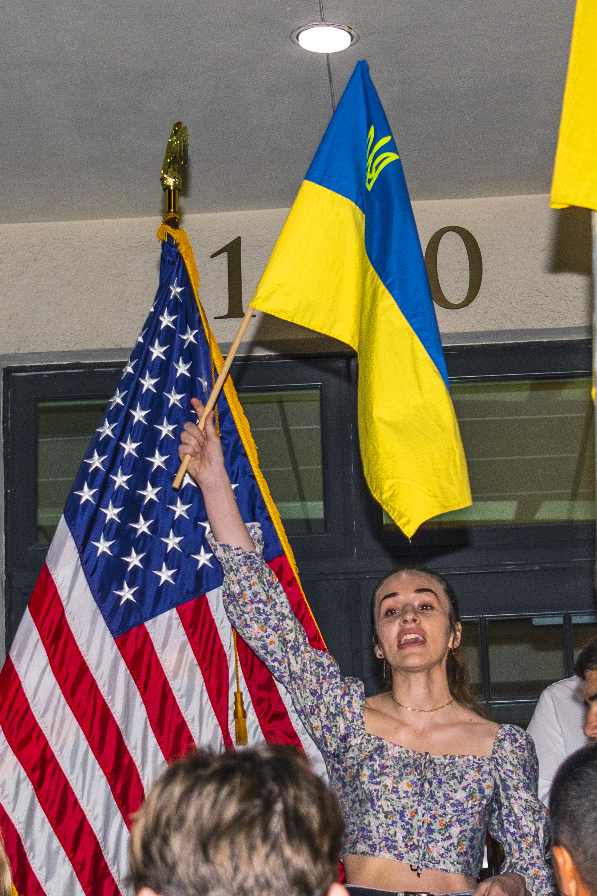 A young Ukraine woman hold her country's flag on Key West City Hall Steps